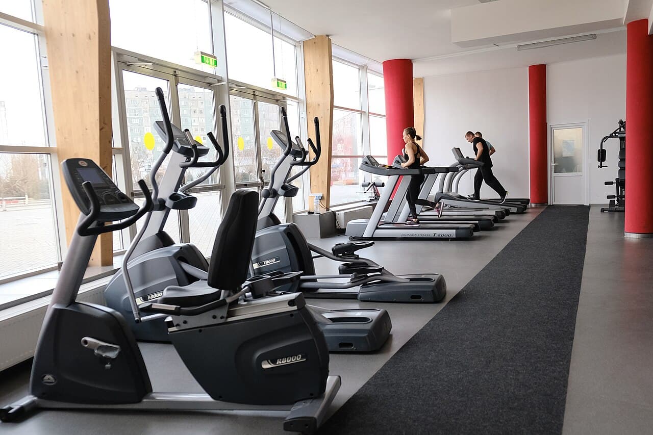Gym members on treadmills and cardio equipment, checked in with AnthroGym's QR attendance tracking software